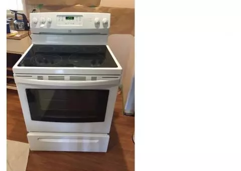 Like new electric range with white refrigerator